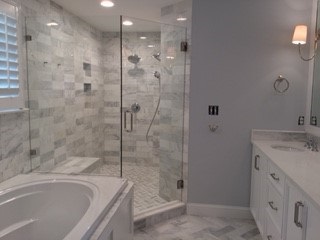 Neo Angle Door and Panel on Clamps Seamless all glass neo angle shower with marble tile in Chapel Hill NC